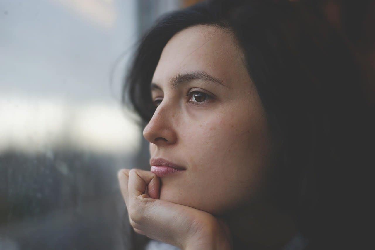 this is an image to represent a woman thiking about her chances of getting cancer, set as a featured image for an article by Dr Suraj Manjunath, one of the best cancer surgeons and surgical oncologist, Bangalore