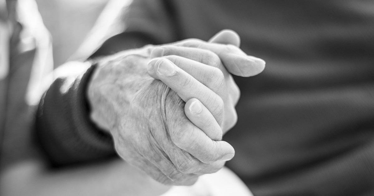 this is an image of an elderly person holding hands with a younger person, used in an article by Dr Suraj Manjunath, cancer surgeon and minimally invasive surgical oncologist, to describe the process of disclosure of a cancer diagnosis